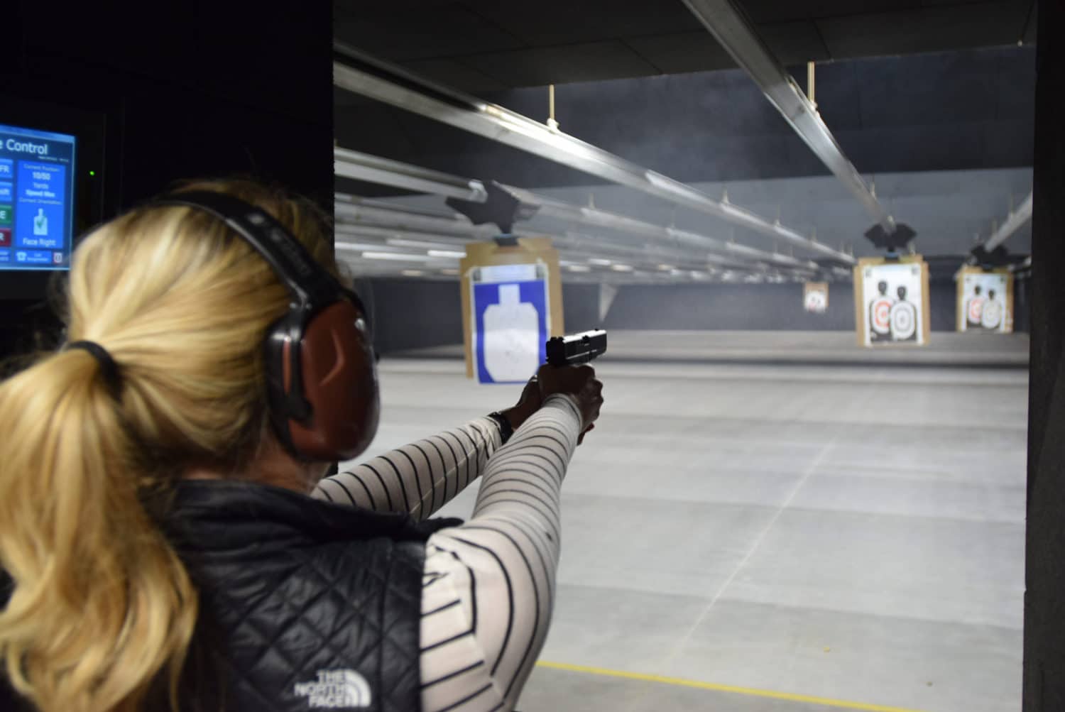 woman shooting indoor gun range
